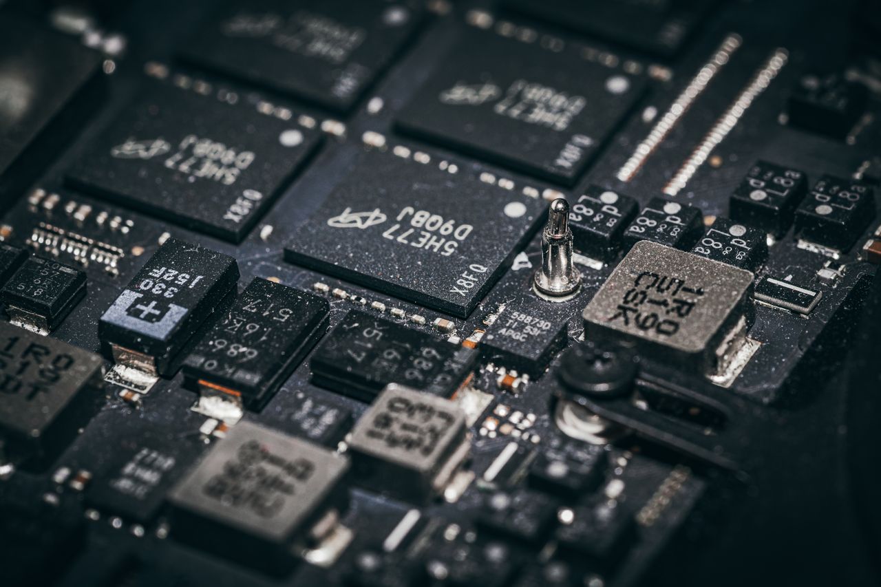 Home Detailed close-up of electronic microchips on a circuit board, showcasing technology and engineering intricacies.